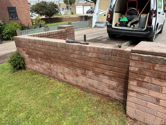 Brick boundary wall after professional cleaning in Bristol with restored brickwork and improved appearance